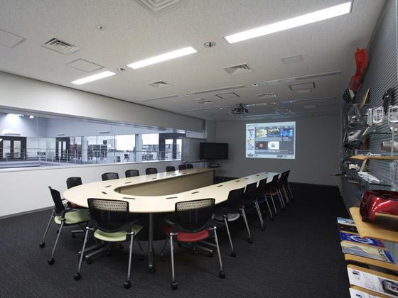 TAKUBO ENGINEERING CO., LTD./【Conference room】Conference room with a view of both the assembly factory floor and an office