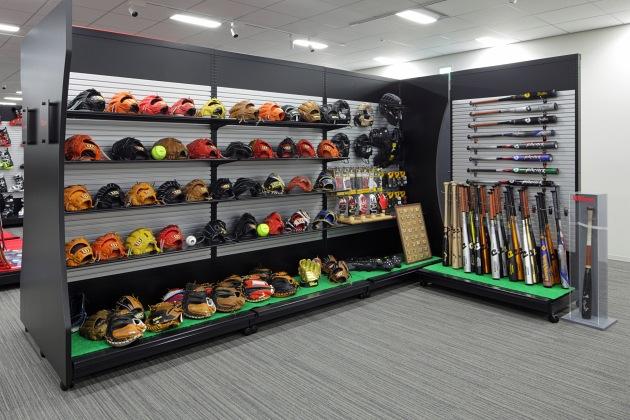 Amer Sports Japan, Inc./【Showroom area】Double- and single-sided display cases display baseball goods.
