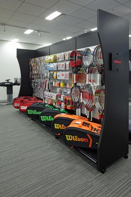 Amer Sports Japan, Inc./【Showroom area】Single-sided display cases display tennis goods.