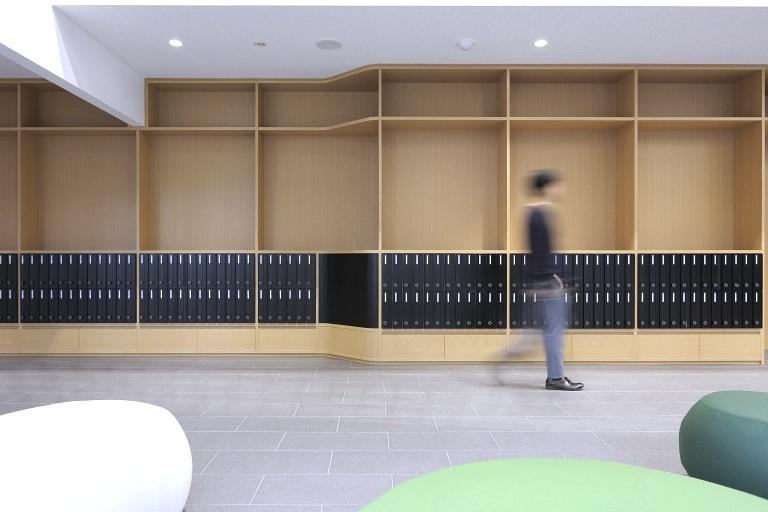 Sendai Oroshisho Center/【Culture lounge】In addition to functioning as post office boxes, the wall storage also serves as a bulletin board for displaying posters to people passing by.